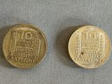 two coins are sitting on a table next to each other