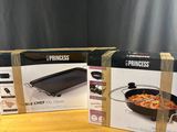 three boxes of princess grills sitting on a wooden table