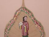 two decorative ornaments hanging on the wall of a bathroom