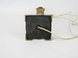 a small black object with a gold crown on it