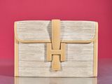 an image of a white and tan purse sitting on top of a table