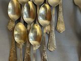 a lot of silver spoons and forks on the table