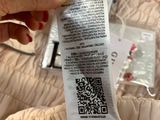 a person holding a white purse with a qr code on it