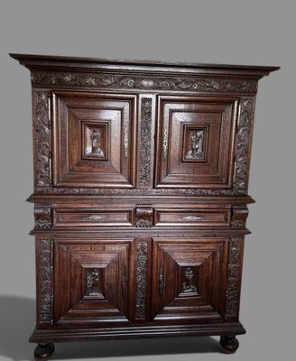 une grande armoire en bois dont les portes sont ornées de sculptures