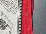 a close up of a red and white scarf with a black and white design