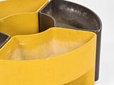a yellow and black bowl on a white surface
