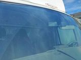 a white van with a white roof parked in a parking lot