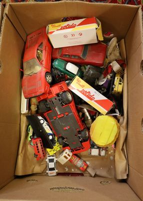 a cardboard box filled with assorted toys and other items