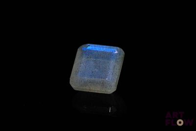 a close up of a square blue stone on a black surface