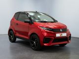 a red car is parked in a white room with a black floor
