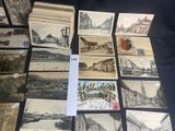 several old postcards of different types and sizes are on a table