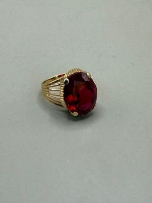 an image of a ring with a red stone in it