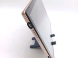 a tablet that is sitting on a stand on a table