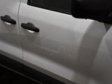 a close up of a white car with a black door handle