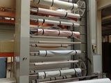 a machine that is making rolls of paper in a factory