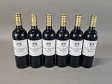 six bottles of wine are lined up in a row
