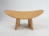 an image of a small wooden bench with a curved seat