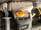 a drill that is sitting on top of a piece of metal