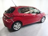 a picture of a red car that is parked in a garage