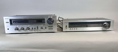 two stereo systems sitting next to each other on a table