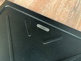 a close up of a black laptop on a wooden table