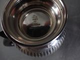 a silver cup that is sitting on a table