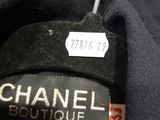 a label on a black shirt that says chanel boutique
