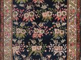 an antique persian rug with a floral design