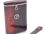 brown tortoise shell cigarette case with a silver plated cigarette opener