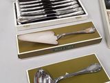 a silverware set in a box with a spoon and a spoon rest