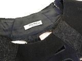 the back of a black jacket with a label on it