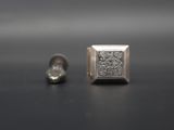 pair of white gold and diamond earrings on a black surface