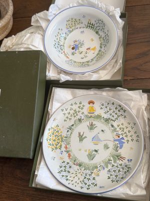 two plates and a bowl in a box on a table