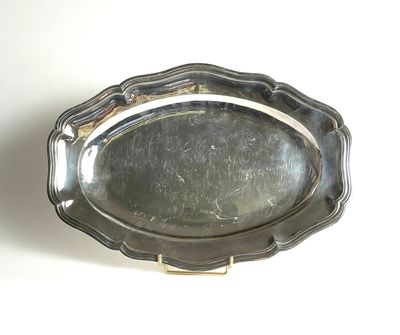 a silver plate with a handle on a white surface