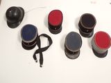 five hats on a table with a black hat on top of them