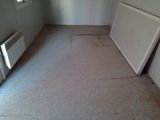 a picture of a dirty room with a radiator in it