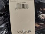 a label on the back of a black jacket