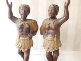 pair of bronze figurines of a boy and a girl holding a fan