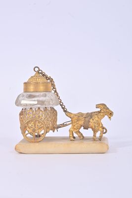 a gold figurine of a horse pulling a carriage with a man on it