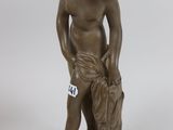 an image of a statue of a boy with a bag on his shoulder