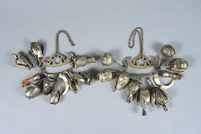 pair of silver plated earrings with leaves and birds on them