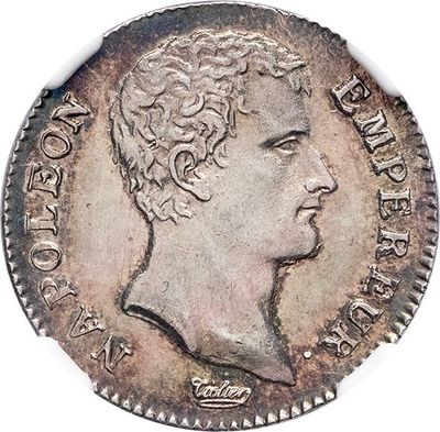 a close up of a coin with a man ' s head on it