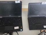 two laptops that are sitting on a table