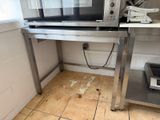 a microwave that is sitting on a table in the kitchen