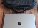 a laptop and a bag on a wooden floor