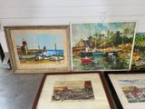 three framed pictures of boats on display in a room