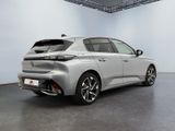 the rear end of a silver car in a white room