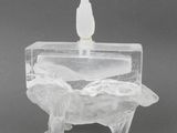 an image of a clear glass candle holder with a bird on top of it