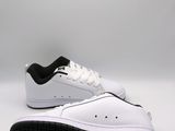 a close up of a pair of white shoes with black soles