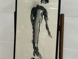 a picture of a man standing in front of a painting on a easel